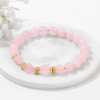 Rosenquarz Perlenarmband mit facettierten Mittelsteinen