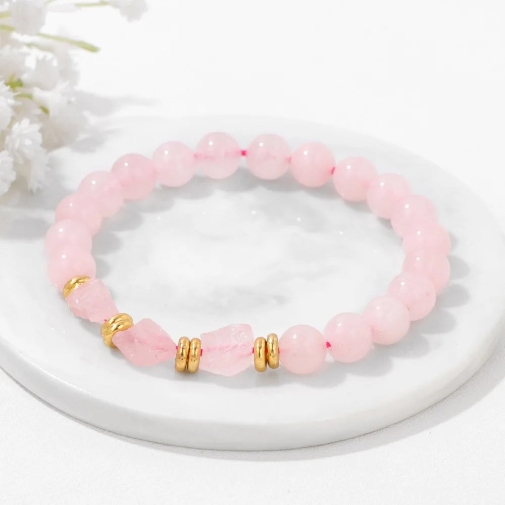 Rosenquarz Perlenarmband mit facettierten Mittelsteinen