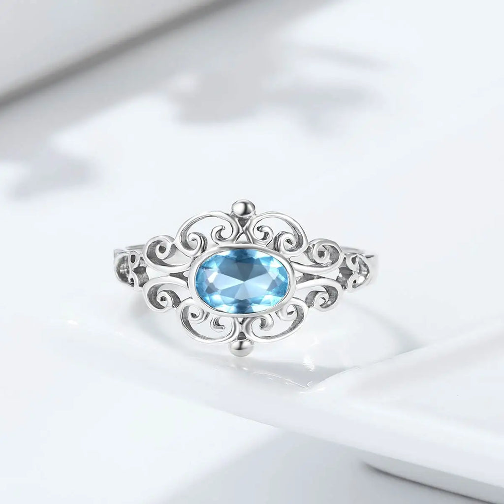 Jugendstil Aquamarin Ring aus 925er Silber mit ovalem Stein und Voluten