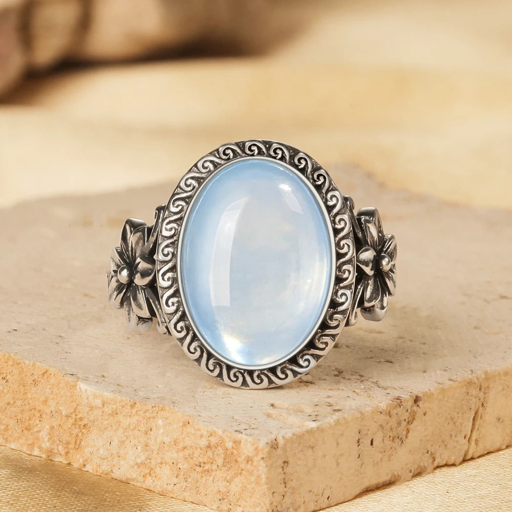 Aquamarin Cabochonring aus 925er Silber mit Blüten und Spiralrahmen