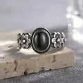Onyx Ring aus 925er Silber mit seitlichen Blüten