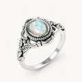 Opal Ring mit rundem Stein und Flechtrahmen